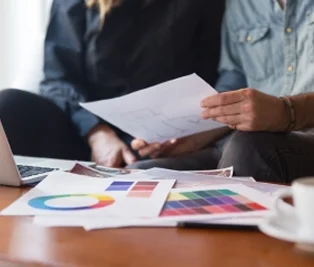 Creative team reviewing press and brand materials