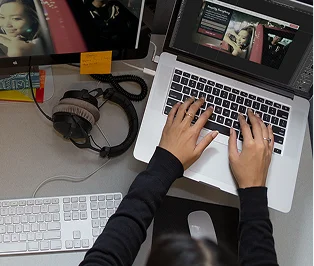 Designer working on an author website at a laptop